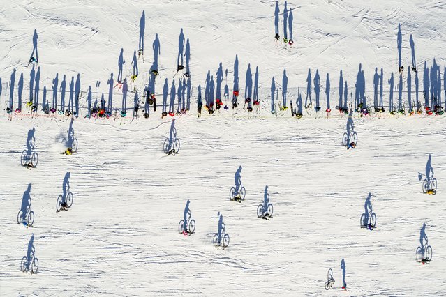 A picture taken with a drone shows cyclists taking part in the 31st edition of the “GP St-Sylvestre”, a new-year snow mountain bike race, in the alpine resort of Villars-Sur-Ollon, Switzerland, 31 December 2019. Over 150 cyclists, some dressed in costumes, took part in the competition on the ski slopes in Villars-Sur-Ollon. (Photo by Valentin Flauraud/EPA/EFE)