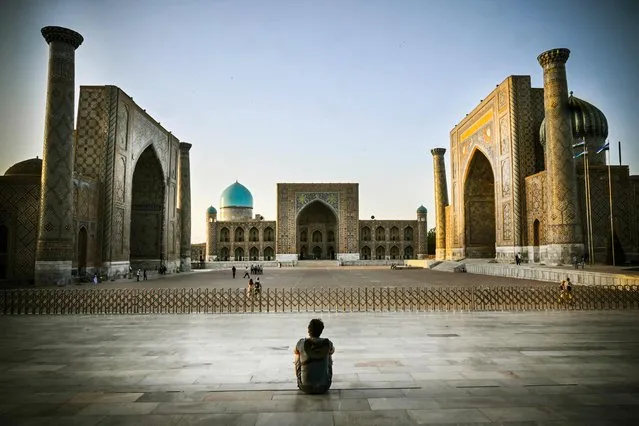 A man sits at the Registan square in downtown Samarkand on September 13, 2022. A regional summit this week where Russian President Vladimir Putin will meet China's Xi Jinping and other Asian leaders will showcase an “alternative” to the Western world, the Kremlin said on September 13, 2022. Putin and Xi will be joined by the leaders of India, Pakistan, Turkey, Iran and several other countries for the summit of the Shanghai Cooperation Organisation (SCO) in the Uzbek city of Samarkand on 16-17 September 2022. (Photo by Alexander Nemenov/AFP Photo)