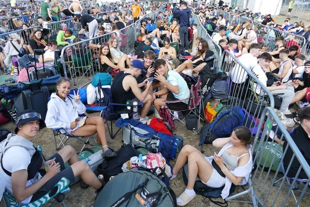 Music fans queue with their camping gear as they wait to get into the Reading festival in Reading, United Kingdom on August 24, 2022. (Photo by Geoffrey Swaine/Rex Features/Shutterstock)