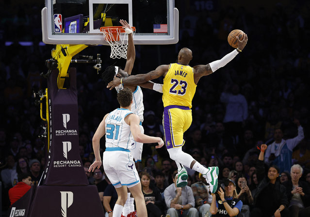 LeBron James #23 of the Los Angeles Lakers makes a slam dunk against Mark Williams #5 of the Charlotte Hornets in the second half at Crypto.com Arena on February 19, 2025 in Los Angeles, California. (Photo by Ronald Martinez/Getty Images/AFP Photo)