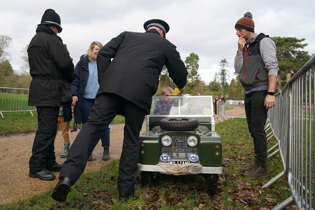 A police officer issues a mock parking ticket to Oliver Ward as he arrives in his toy car to see King Charles III attend a Sunday church service at St Mary Magdalene Church in Sandringham, Norfolk on Sunday January 7, 2024. (Photo by Joe Giddens/PA Images via Getty Images)