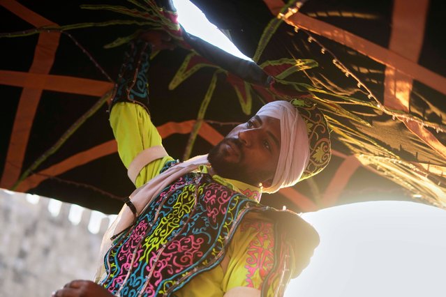 A whirling dervish spins at a restaurant ahead of Iftar, the evening meal breaking the Ramadan fast, in front of Bab al-Futuh, one of the remaining gates of the old city of Cairo, Egypt, Saturday, March 22, 2025. (Photo by Amr Nabil/AP Photo)