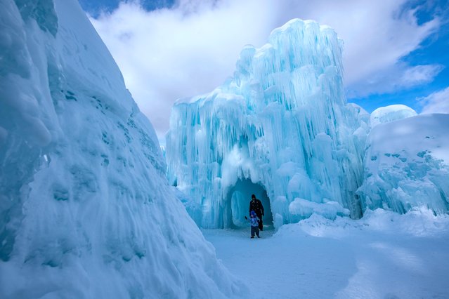 People trek through the caverns and snow at Ice Castles in North Woodstock, New Hampshire on February 8, 2025. Founder Brent Christensen, crafted his first icy creation in the front yard of his home to bring happiness and joy to his children. Since 2011, Ice Castles has been dedicated to creating a world of ice caves, frozen waterfalls, and glaciers formed into archways, caverns, slides, and tunnels. (Photo by Joseph Prezioso/AFP Photo)