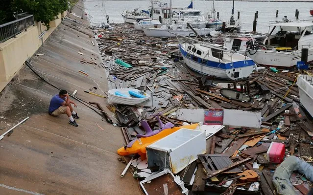 Allen Heath surveys the damage to a private marina after it was hit by Hurricane Hanna, Sunday, July 26, 2020, in Corpus Christi, Texas. Heath's boat and about 30 others were lost or damaged. (Photo by Eric Gay/AP Photo)