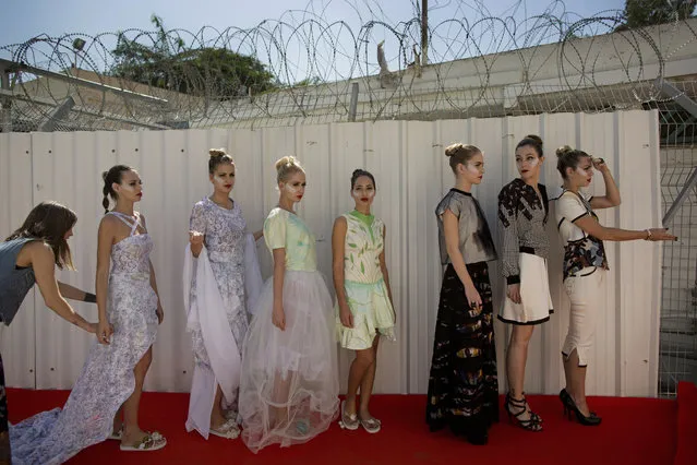 In this Monday, October 27, 2014 photo, models stand in line waiting to walk a runway for a fashion show in Neve Tirza prison in Ramle, central Israel. (Photo by Oded Balilty/AP Photo)