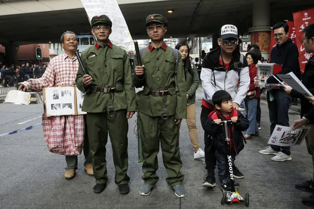 Pro-democracy protesters dress as soldiers of Chinese People's Liberation Army (PLA) during a rally in Hong Kong, Monday, January 1, 2018 as they are against influence from Beijing on the Hong Kong's autonomy. (Photo by Kin Cheung/AP Photo)