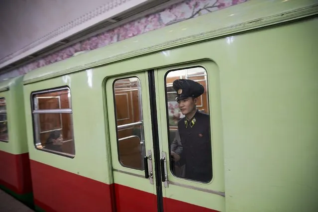 A railway worker looks from inside a train leaving a subway station visited by foreign reporters during a government organised tour in Pyongyang, North Korea October 9, 2015. (Photo by Damir Sagolj/Reuters)
