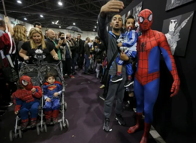 A participant dressed as superhero Spiderman poses for a picture with fans during the first edition of the HeroFestival in Marseille, November 9, 2014. (Photo by Jean-Paul Pelissier/Reuters)