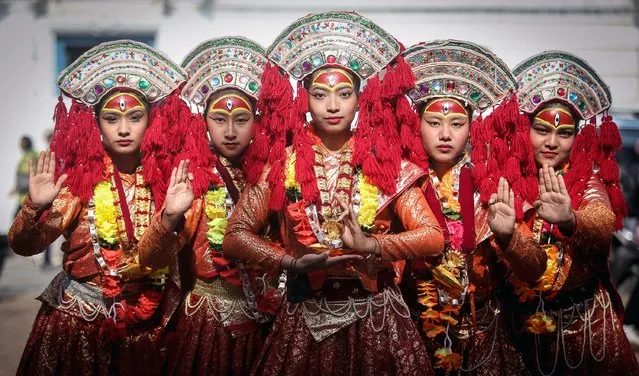 Girls dressed up as Living Goddess Kumari perform during 28th Metropolitan Day organized by Kathmandu Metropolitan City in Kathmandu on December 15, 2022. (Photo by Sunil Sharma/ZUMA Press Wire/Alamy Live News)