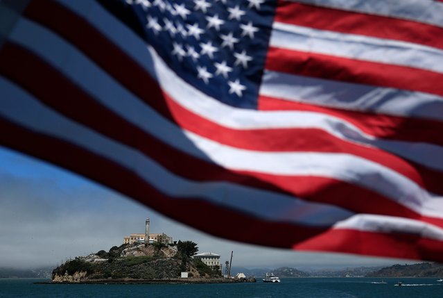 American flag flies on a boat leaving Alcatraz Island on July 02, 2025 in San Francisco, California. U.S. President Donald Trump renewed his plans to reopen the tourist attraction Alcatraz prison as a working federal penitentiary. In a Truth Social post on Tuesday, President Trump said that conceptual work to renovate the prison had begun six months ago, and several prison development firms have been involved in preliminary planning. (Photo by Justin Sullivan/Getty Images)