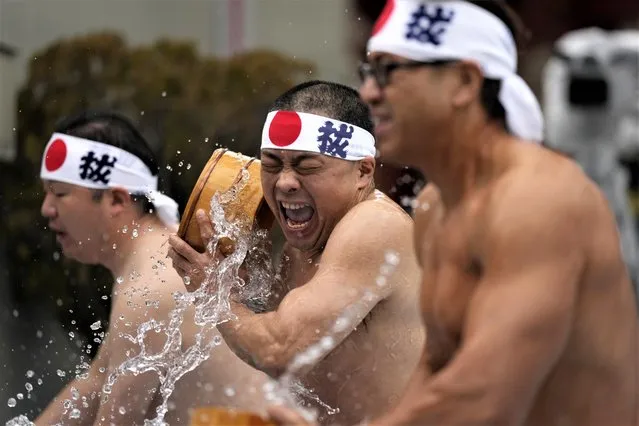 Half-naked shrine parishioners douse themselves with cold water during a cold-endurance ritual at the Kanda Myojin Shinto shrine in Tokyo, Saturday, January 14, 2023. Pouring cold water on their bodies is believed to be purifying their souls. The ritual was part of a two-day Shinto festival. (Photo by Hiro Komae/AP Photo)