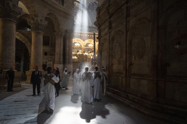 Coptic priests mark the Palm Sunday procession at the Church of the Holy Sepulchre, where many Christians believe Jesus was crucified, buried and rose from the dead, in the Old City of Jerusalem, Sunday, April 28, 2024. (Photo by Leo Correa/AP Photo)