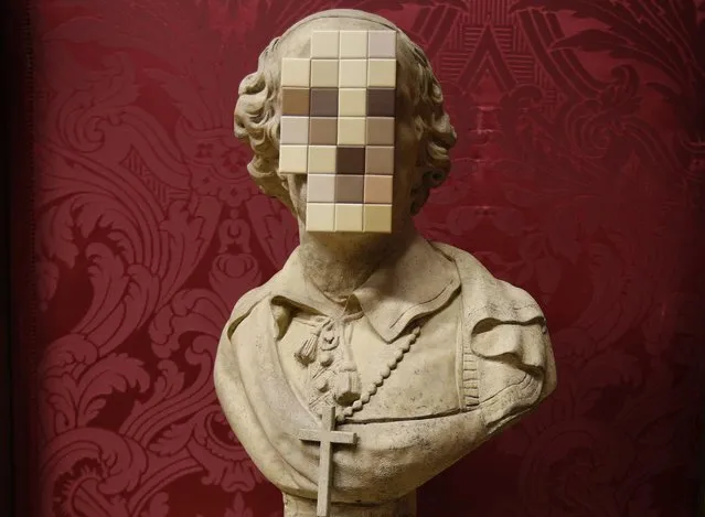 “Cardinal Sin” a work by British artist Banksy is unveiled at the Walker Art Gallery in Liverpool, December 16, 2011. (Photo by Phil Noble/Reuters)