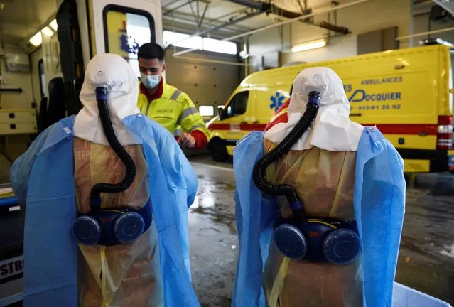 Medical staff members of M2 Ambulance company wear their protective suits as they prepare before the transport of a patient infected with the coronavirus disease (COVID-19) in Ottignies, Belgium, October 23, 2020. (Photo by Johanna Geron/Reuters)