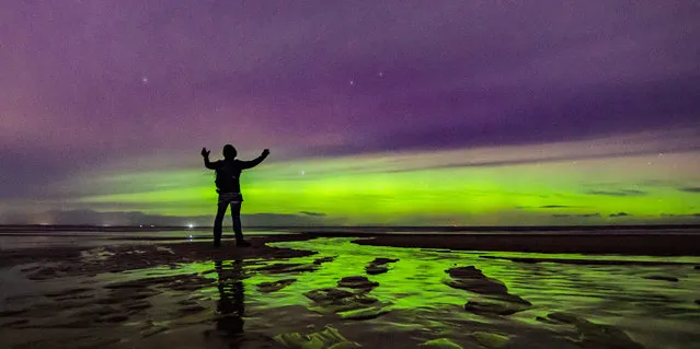 Incredible images capture the northern lights (aurora borealis) seen from the United Kingdom. The stunning colours were seen Friday night, December 30, 2022 from Findhorn Beach, Moray, Scotland. The Aurora is an incredible light show caused by collisions between electrically charged particles released from the sun that enter the earth's atmosphere and collide with gases such as oxygen and nitrogen. The lights are seen around the magnetic poles of the northern and southern hemispheres. (Photo by Paul Scott/Capture Media Agency)