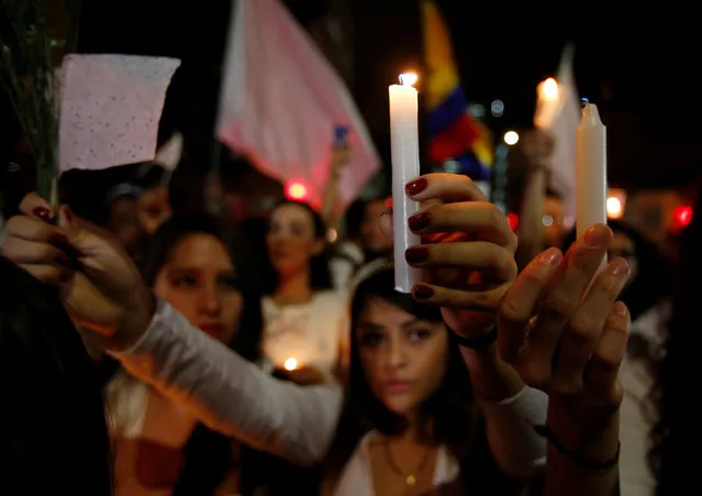 Supporters of the peace deal signed between the government and the Revolutionary Armed Forces of Colombia (FARC) rebels gather at Bolivar Square during a “Silent March” in Bogota, Colombia, October 5, 2016. (Photo by John Vizcaino/Reuters)