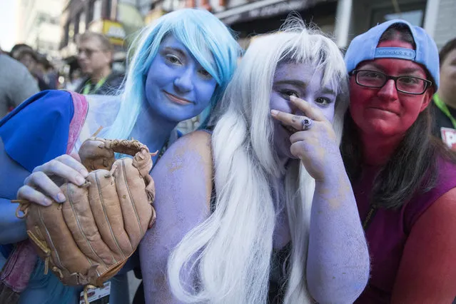Comic Con fans dressed a Crystal Gems from “Steven Universe” pose for a photo, Friday, October 7, 2016, in New York. Comic Con runs through Oct. 9. (Photo by Mary Altaffer/AP Photo)