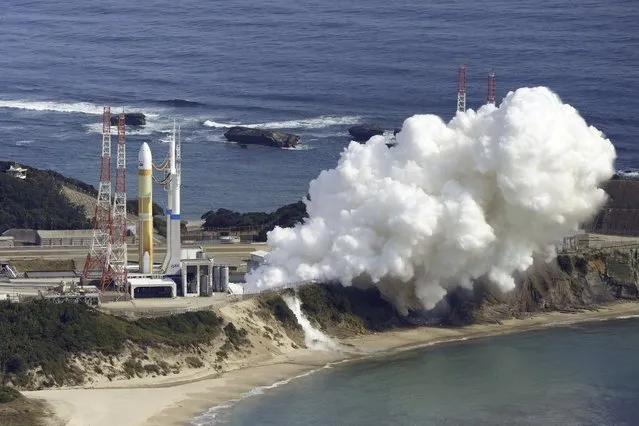An H3 rocket sits on the launch pad next to billowing white smoke at Tanegashima Space Center in Kagoshima, southern Japan Friday, February 17, 2023. Japan’s space agency aborted a planned launch Friday of the first of its new flagship series H3 rocket. (Photo by Kyodo News via AP Photo)