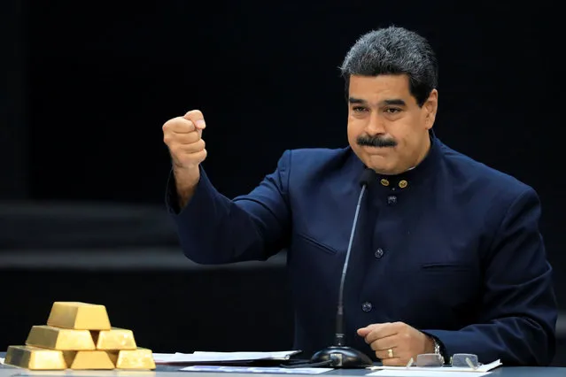 Venezuela's President Nicolas Maduro speaks during a meeting with the ministers responsible for the economic sector at Miraflores Palace in Caracas, Venezuela March 22, 2018. Maduro announced a new set of currency due to soaring inflation. (Photo by Marco Bello/Reuters)