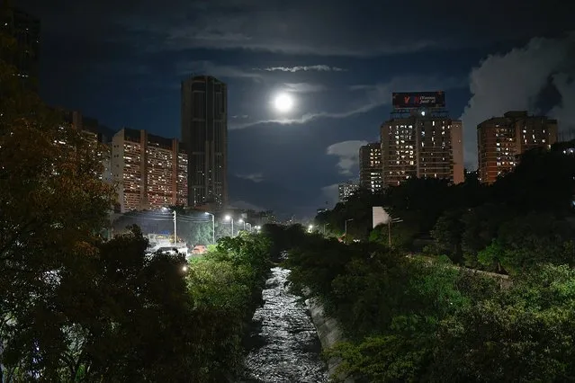 The El Guaire River is illuminated by a full moon in Caracas, Venezuela, Saturday, October 31, 2020, amid the new coronavirus pandemic lockdown. (Photo by Matias Delacroix/AP Photo)