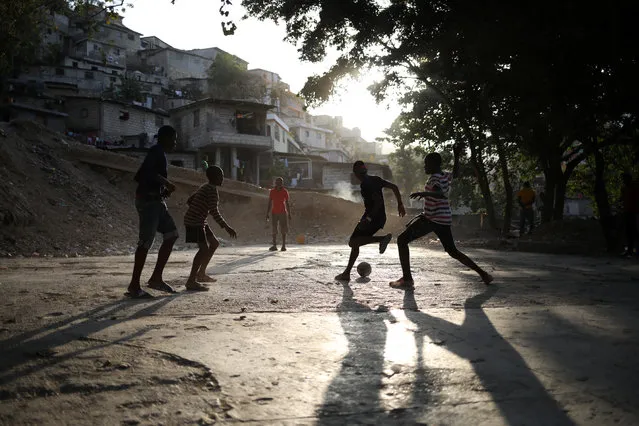 Children play football in Port-au-Prince, March 15, 2018. (Photo by Andres Martinez Casares/Reuters)