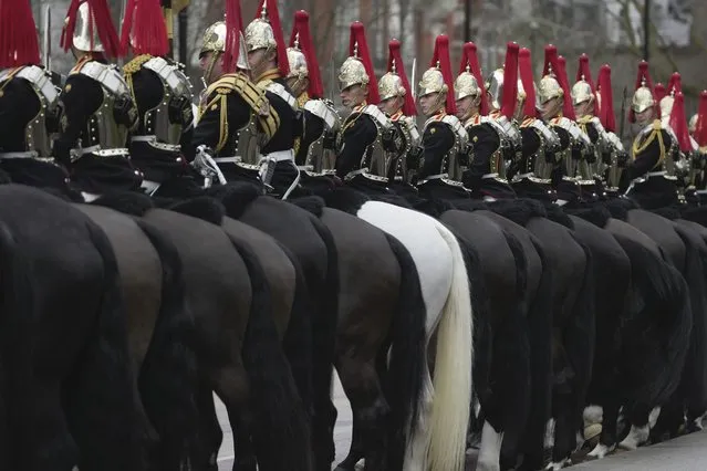 The Household Cavalry Mounted Regiment practices for the state ceremonial at Hyde Park, in London, Wednesday, March 22, 2023. During their annual inspection, they rehearsed their escort form for the King's Birthday Parade, the State Opening of Parliament and various State visits. (Photo by Kin Cheung/AP Photo)