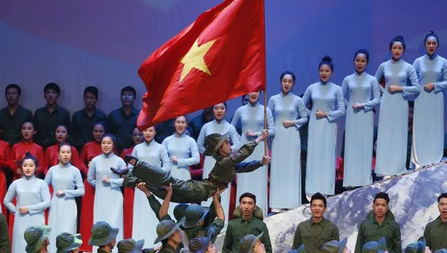 People perform during celebrations to commemorate the 70th anniversary of the establishment of the Vietnam People's Army at the National Convention Center in Hanoi December 20, 2014. (Photo by Reuters/Kham)