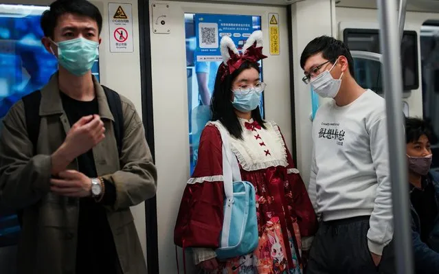 Passengers wear protective masks while riding a subway train on April 21, 2020 in Shanghai, China. Health authorities of China said the country has passed the peak of the COVID-19 epidemic on March 12. As of today, the Coronavirus (COVID-19) pandemic has spread to many countries across the world, claiming over 171,000 lives and infecting over 2.4 million people. (Photo by Yves Dean/Getty Images)