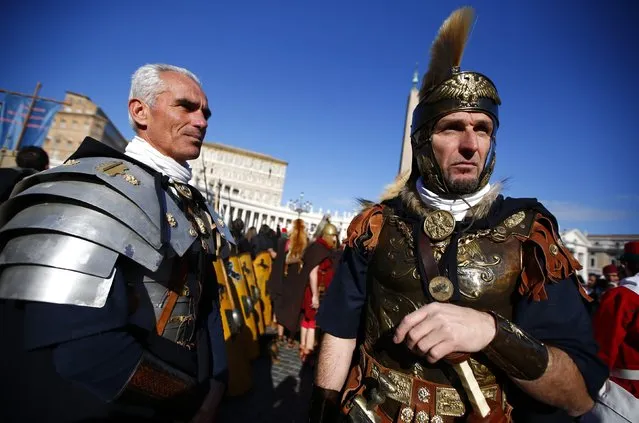 People dressed as ancient Romans look on as Pope Francis leads the Sunday Angelus prayer in Saint Peter's square at the Vatican January 6, 2015. (Photo by Tony Gentile/Reuters)