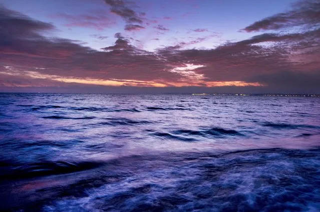 In this Sunday, December 22, 2019 file photo, clouds float over the Baltic Sea before sunrise in Scharbeutz, northern Germany. A joint European-U.S. satellite mission to improve measurements of sea level rise is being launched from Vandenberg Air Force Base in California on Saturday Nov. 22, 2020. The Sentinel-6 Michael Freilich satellite, named after the late director of NASA's Earth Science Division, is seen as a crucial tool for monitoring the impact of global warming on coastlines, where billions of people face the risk of encroaching oceans in the coming decades. (Photo by Michael Probst/AP Photo)