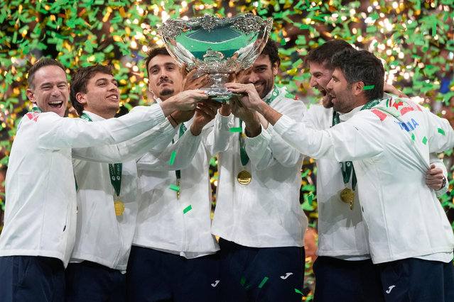 Italian tennis team members hold the Davis Cup trophy after the final between Italy and Spain, in Bologna, Italy, Sunday, November 23, 2025. (Photo by Luca Bruno/AP Photo)