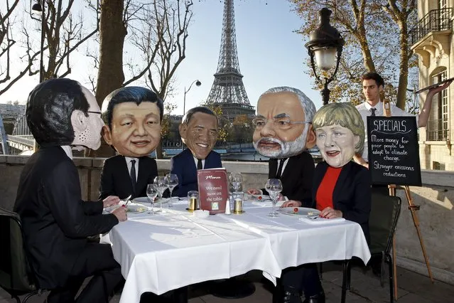 Activists of global anti-poverty charity Oxfam, wearing masks depicting some of the world leaders French President Francois Hollande, Chinese President Xi Jinping, U.S. President Barack Obama, India's Prime Minister Narendra Modi and German Chancellor Angela Merkel, stage a protest ahead of the 2015 Paris Climate Conference, known as the COP21 summit, in Paris, France, November 28, 2015. (Photo by Benoit Tessier/Reuters)
