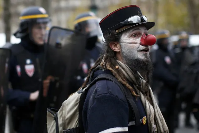 An environmentalist attends a demonstration near French CRS police before clashes at the Place de la Republique after the cancellation of a planned climate march following shootings in the French capital, ahead of the World Climate Change Conference 2015 (COP21), in Paris, France, November 29, 2015. (Photo by Benoit Tessier/Reuters)