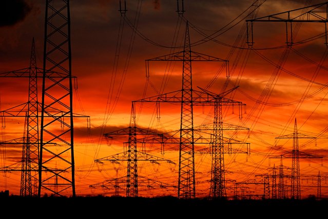 Power poles are seen at a power station operated by German energy giant RWE near Niederaußem, Germany, on Wednesday, November 12, 2025. (Photo by Ina Fassbender/AFP Photo)