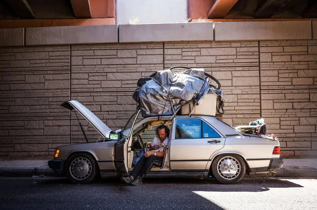 Orlando Santillanes holds his dog Coqueta as he sits inside his broken-down vehicle that has been his home for the past six months in Albuquerque, US on May 23, 2023. (Photo by Chancey Bush/Albuquerque Journal via ZUMA Prees Wire/Rex Features/Shutterstock)