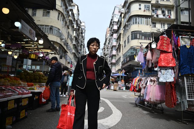 A woman shops on a street in Hong Kong on February 6, 2025. (Photo by Peter Parks/AFP Photo)