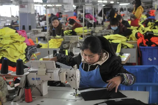 An employee works at a garment factory, which exports products to Europe, in Hefei, Anhui province January 19, 2015. (Photo by Reuters/Stringer)