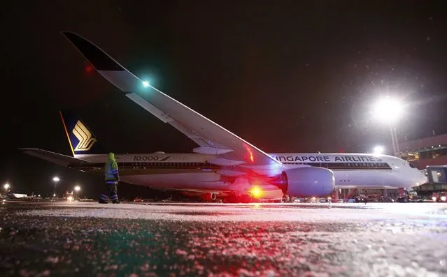 An Airbus A350-900 plane of Singapore Airlines, the 10,000th aircraft produced by Airbus, is seen on the tarmac shortly after its landing at Moscow's Domodedovo airport, Russia, December 15, 2016. (Photo by Maxim Shemetov/Reuters)