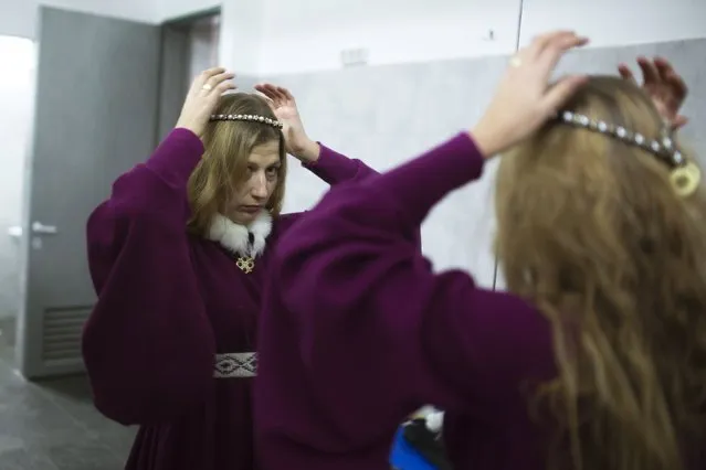 An accompanied woman is seen at the dressing room during the “World Medieval Fighting Championship – the Israeli Challenge” in Rishon Letzion near Tel Aviv on January 22, 2015. (Photo by Amir Cohen/Reuters)