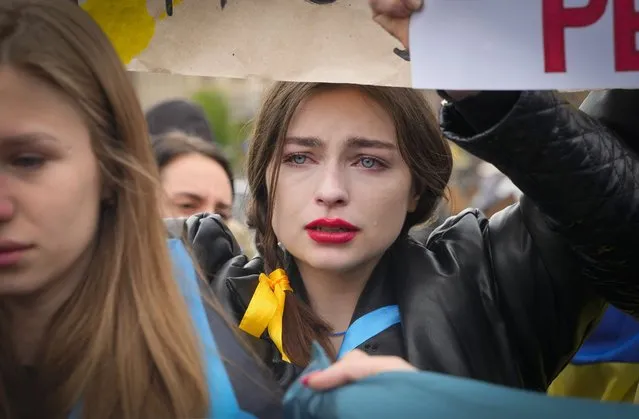 A woman cries as relatives and activists take part in a rally demanding international leaders to organize a humanitarian corridor for evacuation of Ukrainian military and civilians from Mariupol, amid Russia's invasion of Ukraine, in central Kyiv, Ukraine, Saturday, April 30, 2022. (Photo by Efrem Lukatsky/AP Photo)