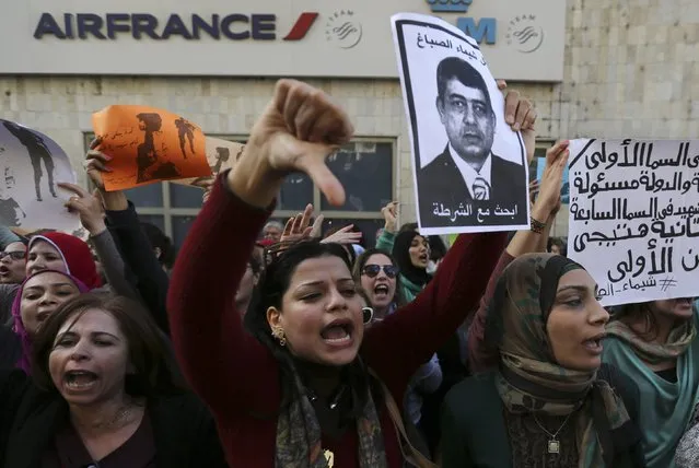 Protesters chant anti-government slogans while holding a poster of Egyptian Interior Minister Mohamed Ibrahim with the words, “Wanted, the killer of Shaimaa al-Sabbagh” during a protest by women at the same location in central Cairo where activist Shaimaa Sabbagh was killed during a protest on Saturday, January 29, 2015, one day before the anniversary of the popular uprising that ousted autocrat Hosni Mubarak in 2011. (Photo by Mohamed Abd El Ghany/Reuters)