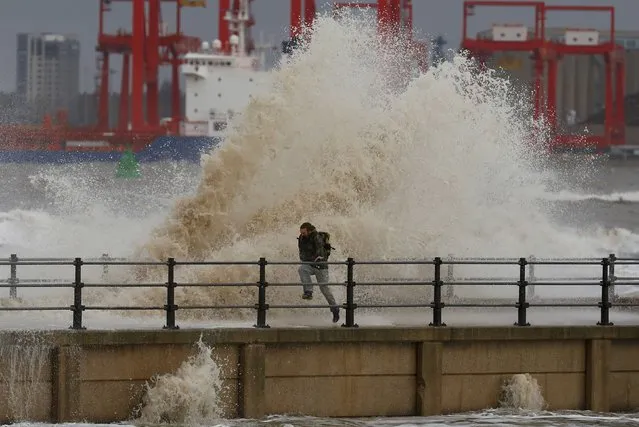 A man is battered by a wave as he walks along the seafront in New Brighton, northern England November 16, 2016. (Photo by Phil Noble/Reuters)