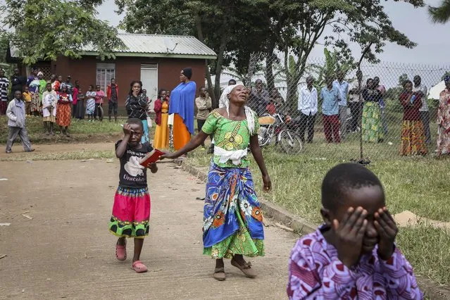 Relatives grieve as they wait to collect the bodies of villagers who were killed by suspected rebels as they retreated from Saturday's attack on the Lhubiriha Secondary School, outside the mortuary of the hospital in Bwera, Uganda Sunday, June 18, 2023. (Photo by Hajarah Nalwadda/AP Photo)