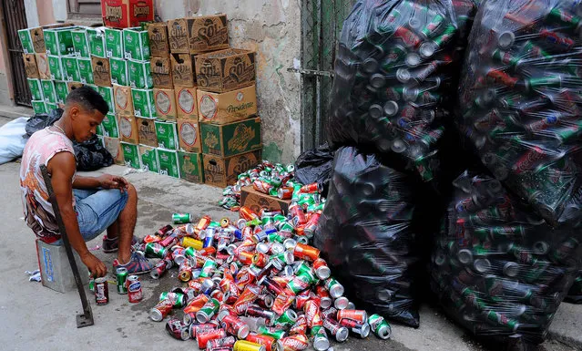 A young man selects cans in Havana, Cuba on June 18, 2018  prepares to recognise the market as part of its socialist economy in a constitutional reform bill its National Assembly will approve this weekend. (Photo by Yamil Lage/AFP Photo)
