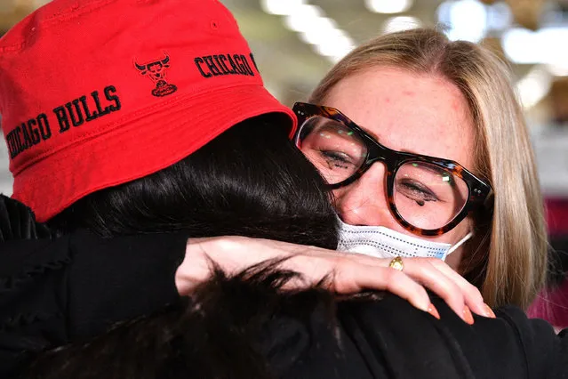 A mother hugs her daughter (L) upon her arrival from New Zealand at Sydney International Airport on April 19, 2021, as Australia and New Zealand opened a trans-Tasman quarantine-free travel bubble. (Photo by  Saeed Khan/AFP Photo)