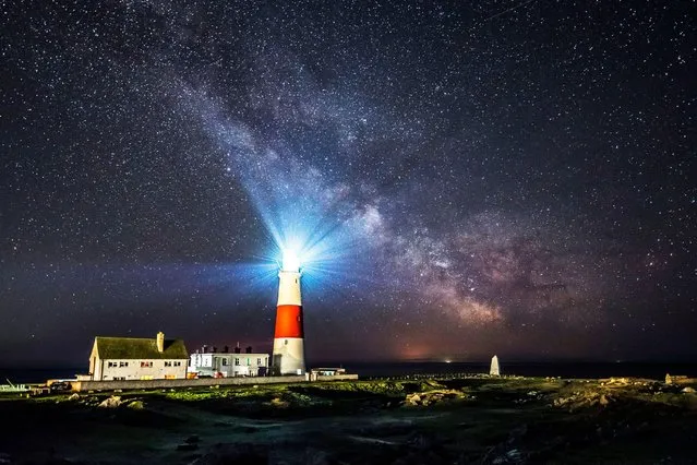 The galactic centre of the Milky Way glows brightly in the clear night sky above the lighthouse at Portland Bill on the Dorset Jurassic Coast, United Kingdom on April 13, 2021. (Photo by Graham Hunt/Alamy Live News)