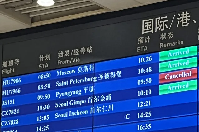 The cancelled status of an Air Koryo flight from North Korea's capital Pyongyang is seen in red on an information board at Beijing Capital international airport on August 21, 2023. North Korea's national airline was set to make its first commercial flight in over three years on August 21 – only to be abruptly canceled at the last minute. (Photo by Oliver Hotham/AFP Photo)