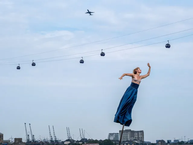 The French circus group Gratte Ciel performed on 32ft  poles for the Greenwich+Docklands festival in London on September 10, 2023. (Photo by Jeff Moore/ALAMY)
