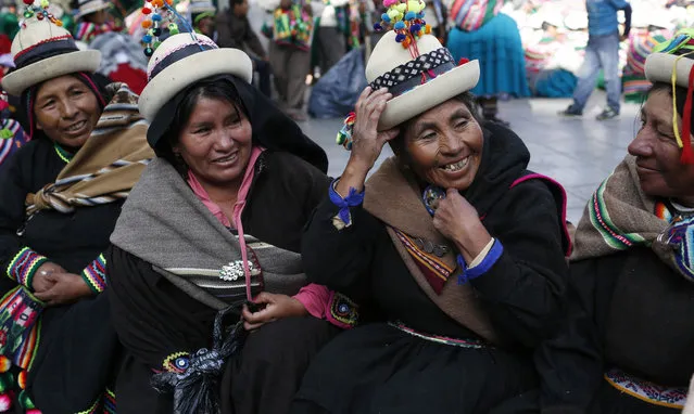 Quechua women gather outside the National Congress before the State of the Nation address, in La Paz, Bolivia, Friday, January 22, 2016. Bolivian President Evo Morales, who won re-election in 2014 to a third term with 61 percent of the vote, is marking 10 years as the leader of the South American country. (Photo by Juan Karita/AP Photo)