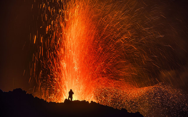 Luc Perrot taking pictures of the erupting volcano. (Photo by Luc Perrot/Caters News)
